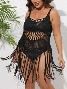 Détail d'une robe de plage en crochet noir avec de longues franges sur l'ourlet en V