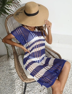 Detail of blue and white striped crochet beach cover-up showing knit mesh texture