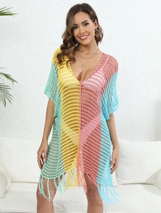 Detail of color-block crochet beach cover-up with V-neckline and tassel hem fringe