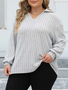 Detail shot of the ribbed texture and polo V-neck design on the light grey knit top