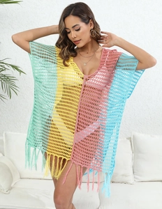 Detail of colorful crochet beach cover-up featuring fringe hem and hollow knit texture
