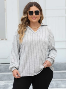 Detail view of grey long sleeve rib-knit polo shirt with V-neckline and collar