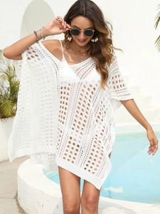 Close-up of white crochet beach cover-up featuring intricate geometric hollow-out patterns