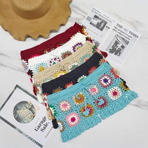Flat lay of colorful crochet granny square shorts with drawstring and scalloped hem