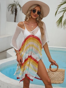 Détail de la tunique de plage au crochet avec motifs à rayures colorées et pompons latéraux