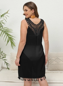 Detail of crochet V-back and fringe hem on a black plus size chiffon beach dress