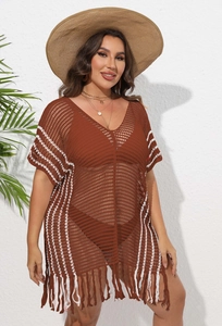 Detail of V-neck crochet beach cover-up featuring white vertical stripes and fringe hem