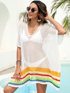 Detailed knit texture of white crochet beach cover-up with vibrant rainbow stripes
