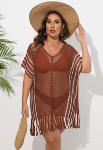 Close-up of brown crochet beach cover-up featuring white stripes and long fringe hem