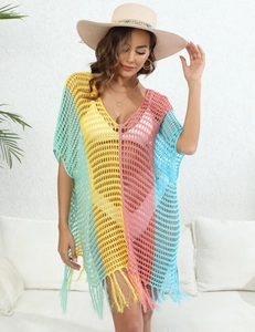 Detail of colorful striped crochet beach cover-up with tassel hem and V-neckline