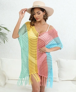 Detail of color block crochet beach cover up with hollow knit texture and long fringe hem