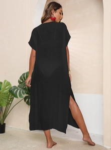 Back view of a long black beach cover-up with high side slits and sheer lightweight fabric