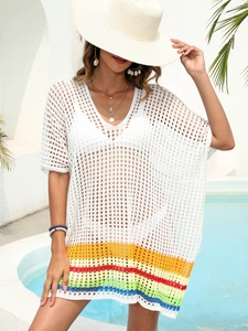 Detail of white crochet beach cover-up featuring vibrant rainbow striped hem design