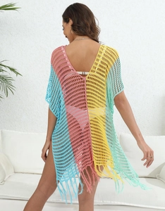Detail of colorful crochet beach cover-up with hollow knit stripes and fringe hem