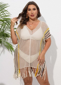 Detail of crochet knit beach cover-up featuring colorful stripes and fringe hem