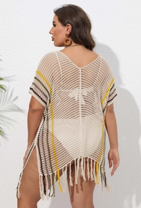 Detail of crochet beach cover-up featuring colorful stripes, side slit and long fringes