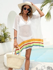 Detailed close-up of white crochet beach cover-up featuring vibrant rainbow striped hem