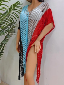 Detail of color-block crochet beach cover-up featuring fringe hem and hollow-out knit texture