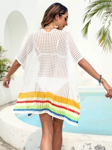 Close-up of crochet hollow out back with rainbow stripes on white beach cover-up