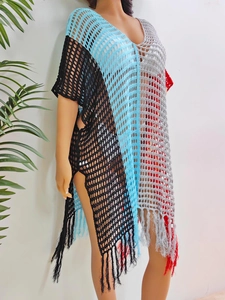 Close-up of crochet knit texture with color-block stitching and fringe hem details