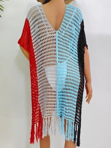 Close-up of color-block knit beach cover-up with hollow mesh and long tassel hem
