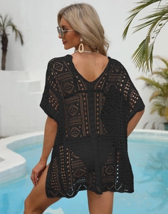 Detailed view of black crochet knit texture and hollow geometric patterns on beach cover-up