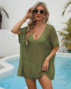 Detail of olive green crochet beach cover-up featuring intricate hollow knit patterns