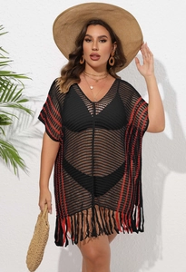 Detail of black crochet beach cover-up featuring red side stripes and long tassel fringe