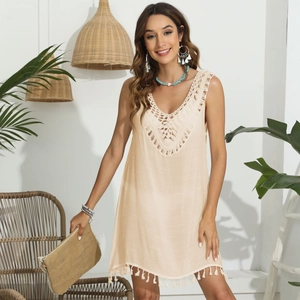 Détails du corsage au crochet en V et ourlet à franges sur une robe d'été en lin beige
