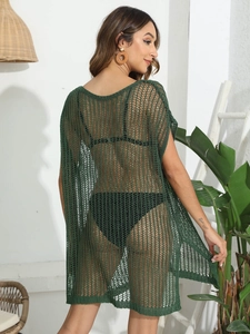 Detail of dark green crochet beach cover-up showing mesh texture and back silhouette