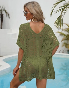Close-up of grass green crochet knit cover-up with geometric hollow out patterns