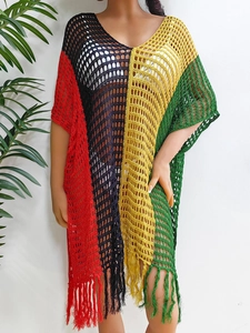 Detail of color-block crochet beach cover-up with mesh hollow knit and long tassel hem