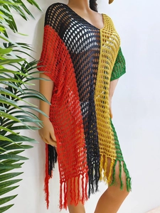 Detail of bohemian crochet beach cover-up with color-block stripes and fringe hem