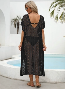 Detail of black crochet lace beach cover-up showing intricate geometric openwork patterns