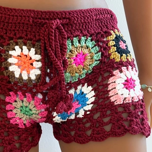 Detail of bohemian crochet beach shorts featuring colorful sunflower grandmother squares
