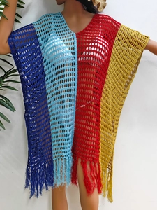 Detail of color-block crochet beach cover-up featuring fringe hem and hollow knit texture