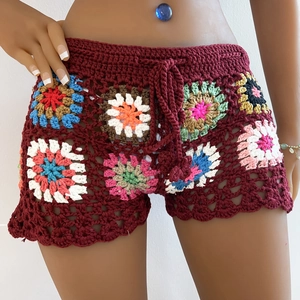 Detail of colorful handmade crochet granny square shorts with burgundy waist drawstring