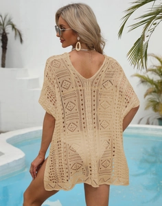 Close-up of beige crochet beach cover-up featuring intricate geometric hollow patterns