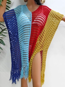 Detail of color-block knit beach cover-up featuring hollow mesh texture and fringe hem
