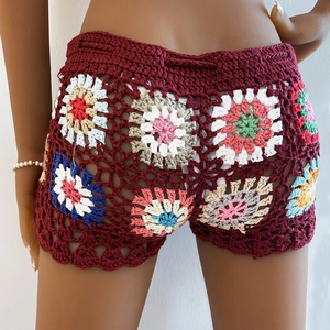 Detail of bohemian handmade crochet shorts featuring colorful floral granny square patterns