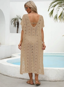 Macro detail of apricot crochet beach cover-up with hollow knit and deep V back design