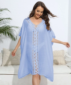 Detail of light blue bohemian cover-up featuring v-neck and handmade crochet lace stitch