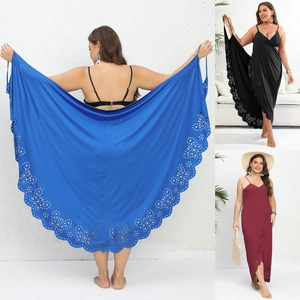 Detail view of large size beach sarong with laser-cut floral patterns in blue, black and red