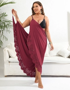 Close-up of laser-cut hollow floral patterns on a dark wine red beach sarong cover-up