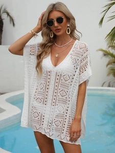 Detailed view of white crochet beach cover-up featuring intricate hollow out geometric patterns