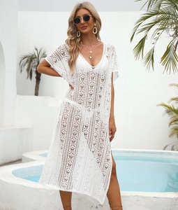 Detail of white crochet beach cover-up featuring geometric hollow-out patterns