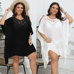 Detail view of crochet V-neck patchwork and ruffled hem on oversized beach cover-ups