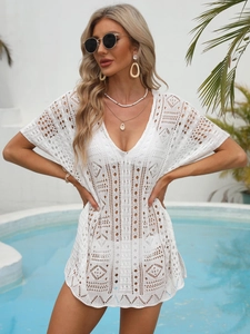 Detailed close-up of white crochet beach cover-up with intricate geometric hollow patterns