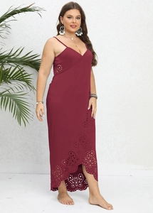 Detail of burgundy plus size dress with cutout floral patterns and irregular hem
