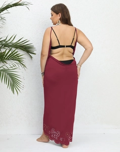 Detail of burgundy backless beach dress featuring intricate laser-cut hollow floral patterns